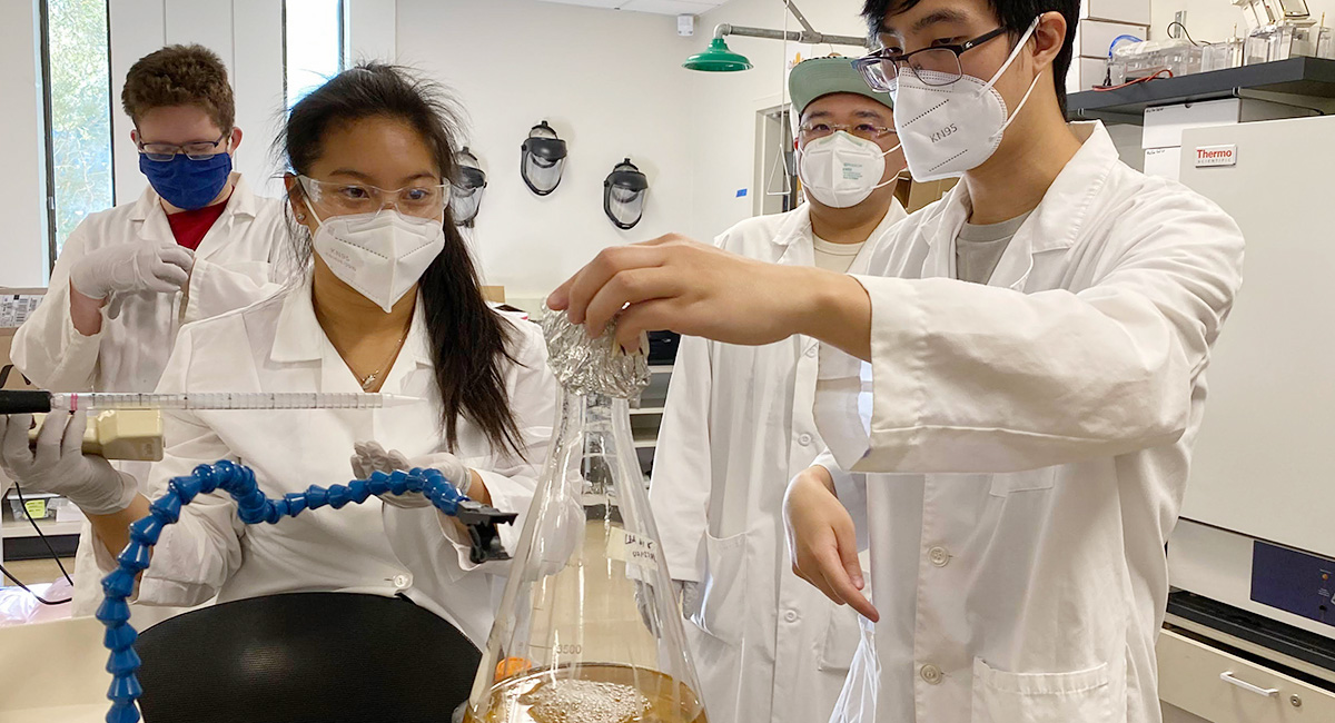 High school students conduct a science experiment